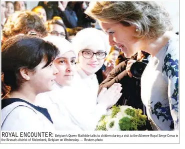  ??  ?? Belgium’s Queen Mathilde talks to children during a visit to the Athenee Royal Serge Creuz in the Brussels district of Molenbeek, Belgium on Wednesday. — Reuters photo