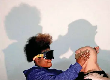  ?? [PHOTOS BY DOUG HOKE, THE OKLAHOMAN] ?? Emerson North student Frankiie Williams practices self-defense techniques while wearing goggles that simulate intoxicati­on during the “My Life, My Body” program at the downtown Oklahoma City school.