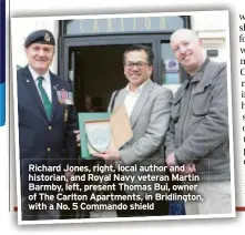  ?? ?? Richard Jones, right, local author and historian, and Royal Navy veteran Martin Barmby, left, present Thomas Bui, owner of The Carlton Apartments, in Bridlingto­n, with a No. 5 Commando shield