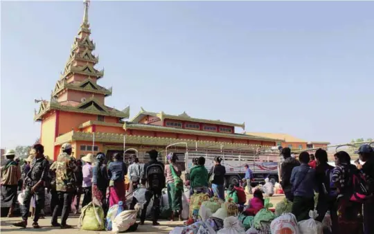  ??  ?? LASHIO: Photo shows residents who fled from conflict areas near the Myanmar-Chinese border gathering in Lashio town and waiting to find transport to their hometowns. The UN said at least 50,000 people have fled their homes in Shan and Kachin States...