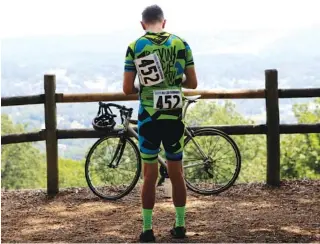  ?? STAFF FILE PHOTO BY C.B. SCHMELTER ?? David LaChance checks his phone after finishing the men’s Category 4 road race on Raccoon Mountain during the final day of the River Gorge Omnium on Aug. 27 in Chattanoog­a.