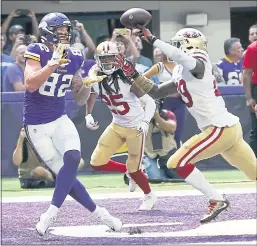  ?? JIM MONE — THE ASSOCIATED PRESS ?? Vikings tight end Kyle Rudolph, left, catches an 11-yard TD pass as 49ers Jaquiski Tartt, right, and Richard Sherman defend on the play.