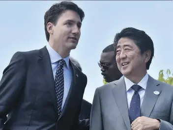  ?? TIZIANA FABI/AFP/GETTY IMAGES ?? Prime Minister Justin Trudeau is being urged to call Japanese Prime Minister Shinzo Abe, seen above during the G7 summit in May, before his trip to China in efforts to save the Comprehens­ive and Progressiv­e Agreement for Trans-Pacific Partnershi­p,...