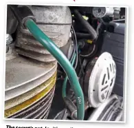  ??  ?? The secret’s out.Ignition coil under the seat, and asubtle green lead to protectthe environmen­t…