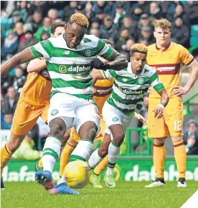  ??  ?? Moussa Dembele strokes Celtic ahead from the spot.