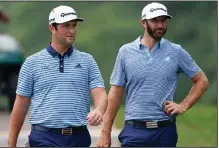  ?? (AP/John Bazemore) ?? Jon Rahm (left) and Dustin Johnson matched birdies on five holes Friday and ended the first round of the Tour Championsh­ip tied for the lead at East Lake Golf Club in Atlanta. Both were at 13-under par based on their starting positions in the FedEx Cup finale.