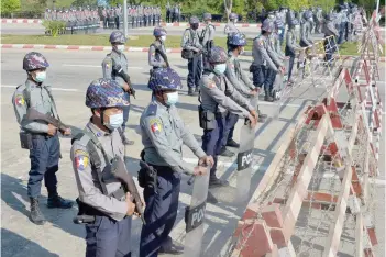  ?? ?? Police stand guard along a road in Naypyidaw on Jan 29, 2021 ahead of the reopening of the parliament on Feb 1 following the November 2020 elections which Suu Kyi’s ruling National League for Democracy (NLD) won in a landslide.