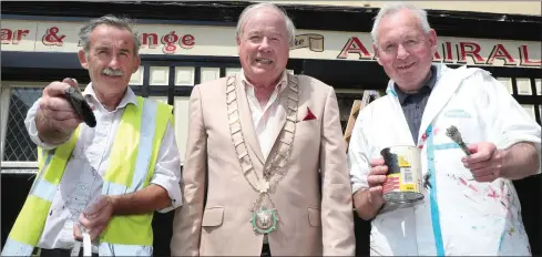  ??  ?? Mayor Frank Godfrey with James and the late Liam Wilson as they painted the outside of The Admirals Pub ahead of the Fleadh Cheoil earlier this year.