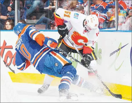  ??  ?? Shawn Horncoff #10 of the Edmonton Oilers loses an edge trying to check Roman Horak #51 of the Calgary Flames during an NHL game at Rexall Place on April
13, in Edmonton, Alberta, Canada. (AFP)