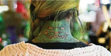  ??  ?? More and more Chinese women are appreciati­ng body art, shrugging off the negativity long associated with tattoos.