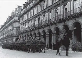  ??  ?? Ernst Jünger (on horseback) with German troops, Paris, 1941