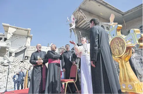  ?? AFP ?? Pope Francis releases a white dove at a square near the ruins of the Syriac Catholic Church of the Immaculate Conception, in the old city of Iraq’s northern Mosul yesterday.