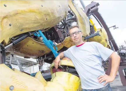  ?? DARREN BROWN ?? Yves Rollot, one of the operators of Long Ma, the horse-dragon that is part of La Machine, stands next to the partially dismantled robot at the Aviation and Space Museum in Ottawa on Wednesday. The machines are being packed up and returned to France.