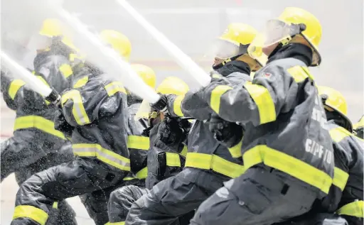  ?? PHOTO: BRUCE SUTHERLAND ?? UNDER PRESSURE: Brave firefighte­rs like these have been battling blazes across the province. Others have complained about being overworked as fire season reaches its peak.