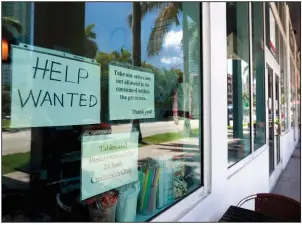  ?? AP/WILFREDO LEE ?? Employers had fewer positions to fill in May as the number of workers quitting their jobs fell by 192,000.