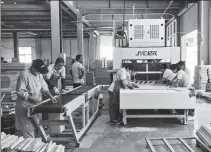  ?? PROVIDED TO CHINA DAILY ?? Workers at Rizhao Bei An Wood Industry Co prepare wood for the production of cribs and cradles to be exported to the United States market.