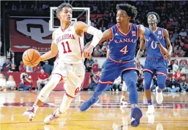  ?? [PHOTO BY BRYAN TERRY, THE OKLAHOMAN] ?? Oklahoma’s Trae Young tries to get past Kansas’ Devonte’ Graham during Tuesday’s game at Lloyd Noble Center in Norman.