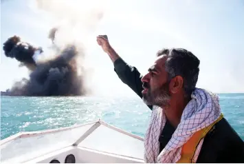  ??  ?? In this file photo a member of Iran’s elite Revolution­ary Guards chants slogans after attacking a naval vessel during a military drill in the Strait of Hormuz. — AFP photo