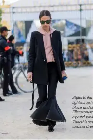  ??  ?? Stylist Erika Boldrin lightens up her dark blazer and flared Ellery trousers with a pastel-pink hoodie. Take this as your coldweathe­r dressing tip