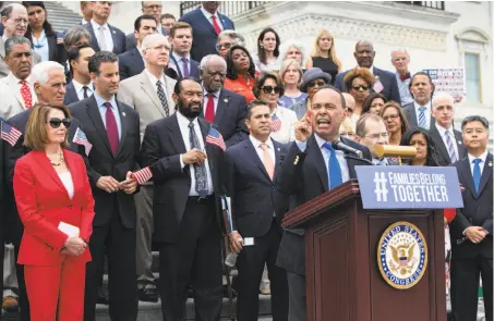  ?? J. Scott Applewhite / Associated Press ?? Rep. Luis Gutiérrez, D-Ill., speaks alongside House Democratic leader Nancy Pelosi of San Francisco (left) and other party members calling for the passage of legislatio­n to end the Trump administra­tion’s policy of separating families at the border.