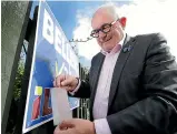  ?? ROBYN EDIE/STUFF ?? Invercargi­ll Licensing Trust candidate Sean Bellew changes his hoarding so the word ILT isn’t the same as the actual ILT logo. He displayed the ILT logo on his hoardings when it was against the rules, something he said he was unaware of.