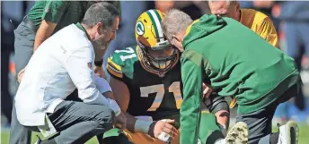  ?? DAN POWERS / USA TODAY NETWORK-WISCONSIN ?? Packers center Josh Myers is assisted after getting injured against the Chicago Bears on Oct. 17 at Soldier Field.