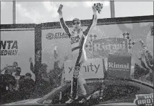  ?? [JOHN BAZEMORE/THE ASSOCIATED PRESS] ?? Kevin Harvick celebrates in victory lane after winning Saturday’s Xfinity race at Atlanta Motor Speedway.