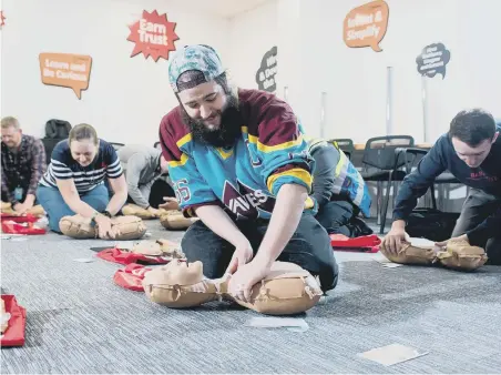  ??  ?? Amazon Operations Supervisor Lloyd Curley practicing CPR on a dummy.