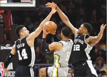  ?? AP/TONY DEJAK ?? San Antonio’s Danny Green (14) and Rudy Gay (22) defend against the Cleveland Cavaliers’ Jordan Clarkson (8) in the first half Sunday in Cleveland.