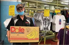  ?? CORNELIUS FROLIK / STAFF ?? Mendelsons customers can fill up a banana box full of itemsto buy in bulk for $19.99 as part of a going-out-of-business sale.