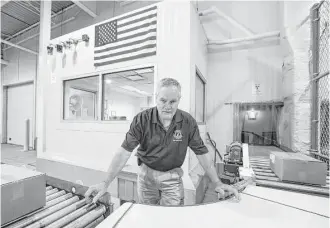  ?? Brett Coomer / Houston Chronicle ?? Facility manager Mickey Speakmon sends items along a conveyor to be run under an electron beam at the National Center for Electron Beam Research at Texas A&M University.