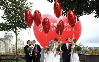  ?? — AFP photo ?? Couples pose during a photo event during a nationwide referendum’s day on same-sex marriage, in Swiss capital Bern.