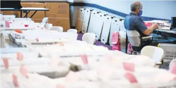  ?? MATTROURKE/AP ?? Dave Turnier processes mail-in ballots at at the Chester County Voter Services office in West Chester before the primary election May 28, .