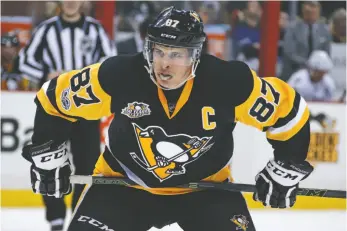  ?? AP FILE PHOTO ?? In this March 3 file photo, Pittsburgh Penguins captain Sidney Crosby prepares for a face-off against the Tampa Bay Lightning in Pittsburgh. The NHL’s divisional playoff format is drawing criticism because two of the top three teams in the league could...