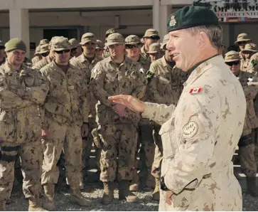  ?? CANADIAN FORCES TRAINING MISSION IN AFGHANISTA­N ?? Lt.-Gen Stuart Beare, commander of Canadian Expedition­ary Force Command, talks to Canadian soldiers stationed at Camp Alamo, Kabul. All of Canada’s troops are scheduled to be out of Afghanista­n by mid-March, 2014.