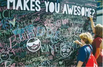  ?? (Mark Boster/Los Angeles Times/TNS) ?? THE CHALKWALL outside was a first stop for many attending the 7th annual VidCon, last month at the Anaheim Convention Center in California.