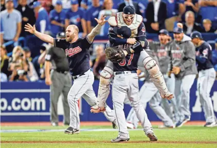  ??  ?? JOHN E. SOKOLOWSKI, USA TODAY SPORTS Catcher Roberto Perez leaps into the arms of closer Cody Allen after the Indians won the American League pennant.