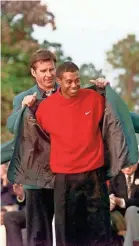  ?? PORTER BINKS/USA TODAY ?? Masters champion Tiger Woods receives his green jacket from the previous year’s winner, Nick Faldo, on April 13, 1997.