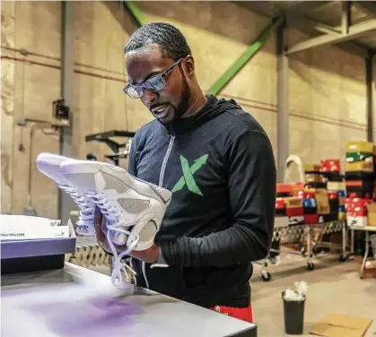  ??  ?? Antonio Gray, 29, of Detroit, worked as a sneaker salesman for six years before becoming an authentica­t over a pair of Jordans. Stock X has created day trading for consumer goods and is doing $2 million in sal