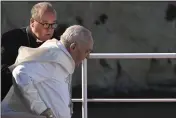  ?? ANDREAS SOLARO — POOL VIA AP ?? Pope Francis is helped by Malta's Archbishop Charles Jude Scicluna, left, aboard a catamaran leaving Valletta's harbor for Gozo in Malta Saturday.