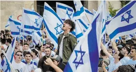  ?? OHAD ZWIGENBERG THE ASSOCIATED PRESS ?? Israelis dance and wave national flags during a march in front of the Damascus Gate of Jerusalem’s Old City, Thursday.