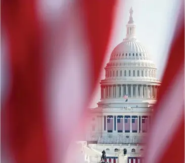  ?? REBECCA BLACKWELL AP ?? The U.S. Capitol is seen through a display of flags on the National Mall, one day after the inaugurati­on of President Joe Biden, on Jan. 21, 2021.