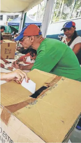  ?? FOTO: EFE ?? ►► Una mujer deposita su voto ayer en Caracas en la consulta convocada por la oposición.