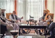  ?? VIA AP TALIBAN ?? Former Afghan President Hamid Karzai, center left, and senior Haqqani group leader Anas Haqqani, right, meet Wednesday in Kabul, Afghanista­n.