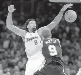  ?? Wally Skalij Los Angeles Times ?? DEANDRE JORDAN of the Clippers def lects a pass by Tony Parker of the San Antonio Spurs in Game 1 of playoff series. The Clippers won, 107-92.