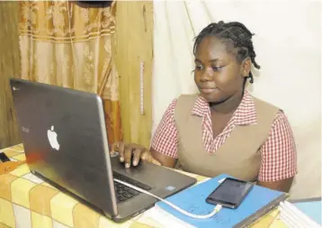  ?? (Photo: Garfield Robinson) ?? Charlemont High School student Vaniecia Burke connects to her classes online at her home in Cheesefiel­d district, St Catherine, last Monday.