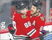  ?? ARMANDO L. SANCHEZ / CHICAGO TRIBUNE ?? Chicago Blackhawks right wing Andrew Shaw (65) celebrates with Patrick Kane (88) after Shaw scored against the Carolina Hurricanes on Feb. 4