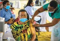  ?? Nicholas Bamulanzek­i Associated Press ?? IN UGANDA, a woman is vaccinated against COVID-19. Less than 7% of the population in Africa is fully vaccinated.