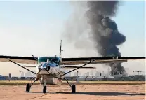  ?? PHOTO: REUTERS ?? Smoke is seen from Melbourne’s Essendon Airport after a charter plane leaving the airport crashed into a shopping centre and exploded, killing five people.