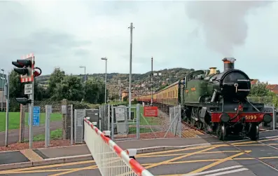  ?? ?? A shunting movement of empty coaching stock by GWR 2-6-2T No. 5199 is the first train to pass over the rebuilt Seaward Way level crossing at Minehead on November 2. KEITH FENDER